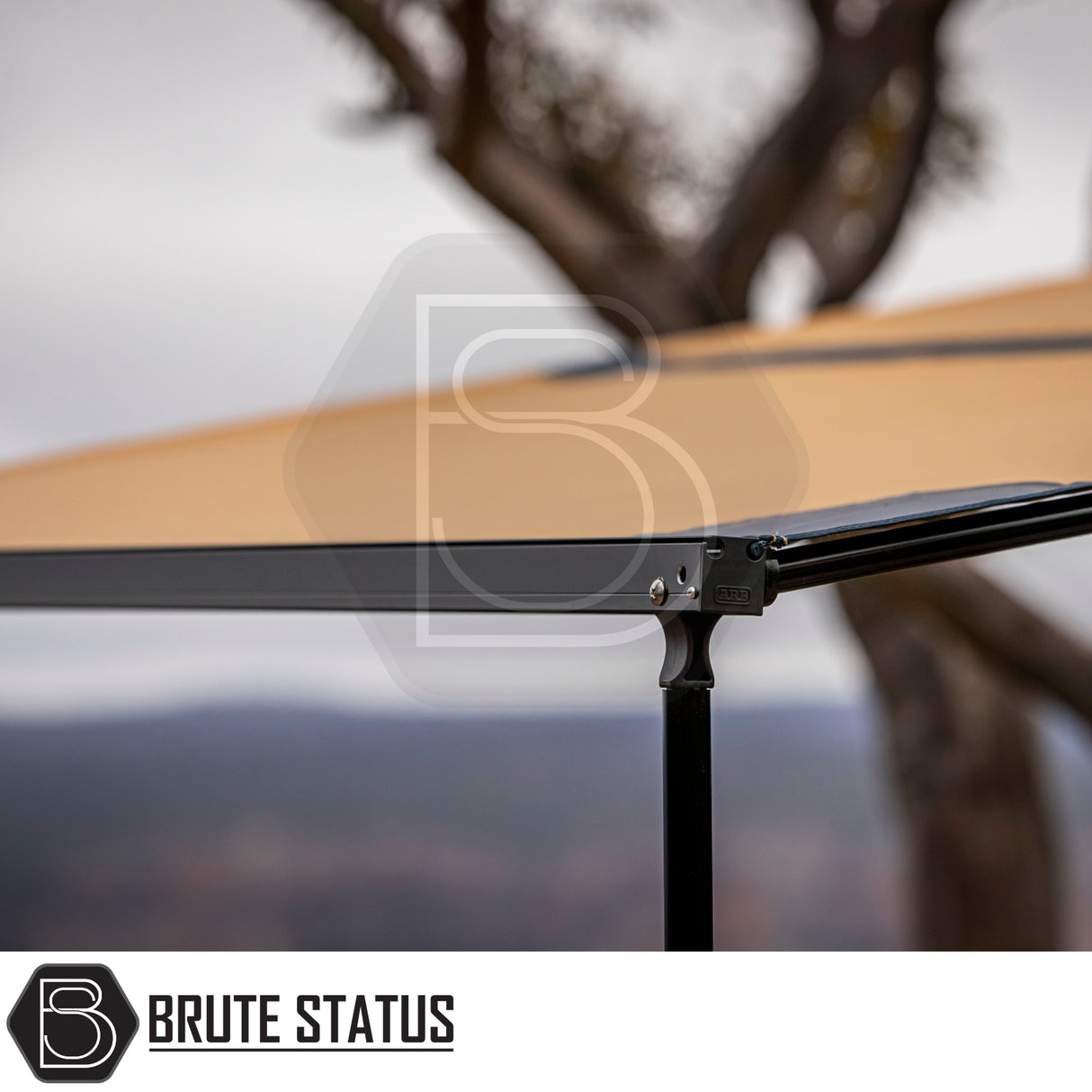 Close-up of ARB Aluminium Case Awning, showcasing tan canopy and bracket with ARB logo, part of a versatile 2.5m x 2.5m overland setup.