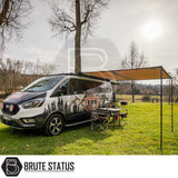 ARB Awning with Light Black Aluminium Case 3m x 2.5m on a camper-van in a field, showcasing easy setup and integrated lighting for outdoor comfort.