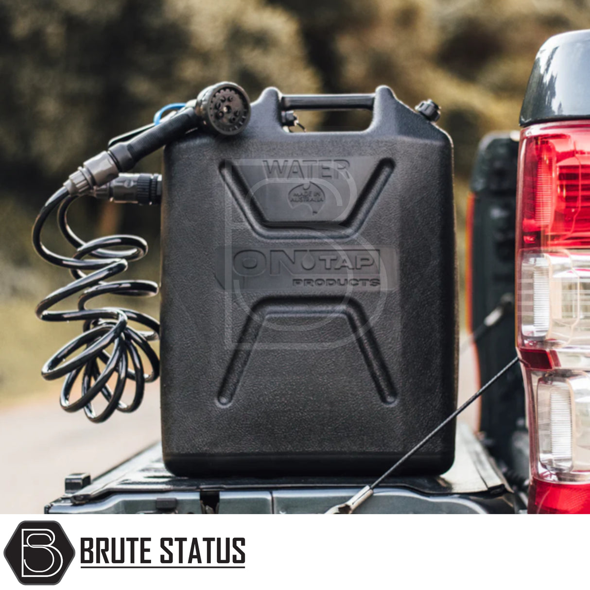 Portable water-jerry can sprayer by On Tap Products, ideal for campsite use, on pickup truck. Equipped with coiled hose and spray nozzle for versatile outdoor cleaning.