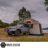 Four-wheel-drive pickup with ARB Simpson III Rooftop Tent and Annex, equipped for overland camping, parked by a lake with off-road accessories.