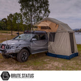 Silver 4×4 with ARB Simpson III Rooftop Tent and Annex, parked lakeside, showcasing overland camping setup with jerry cans, bull-bar, and winch.