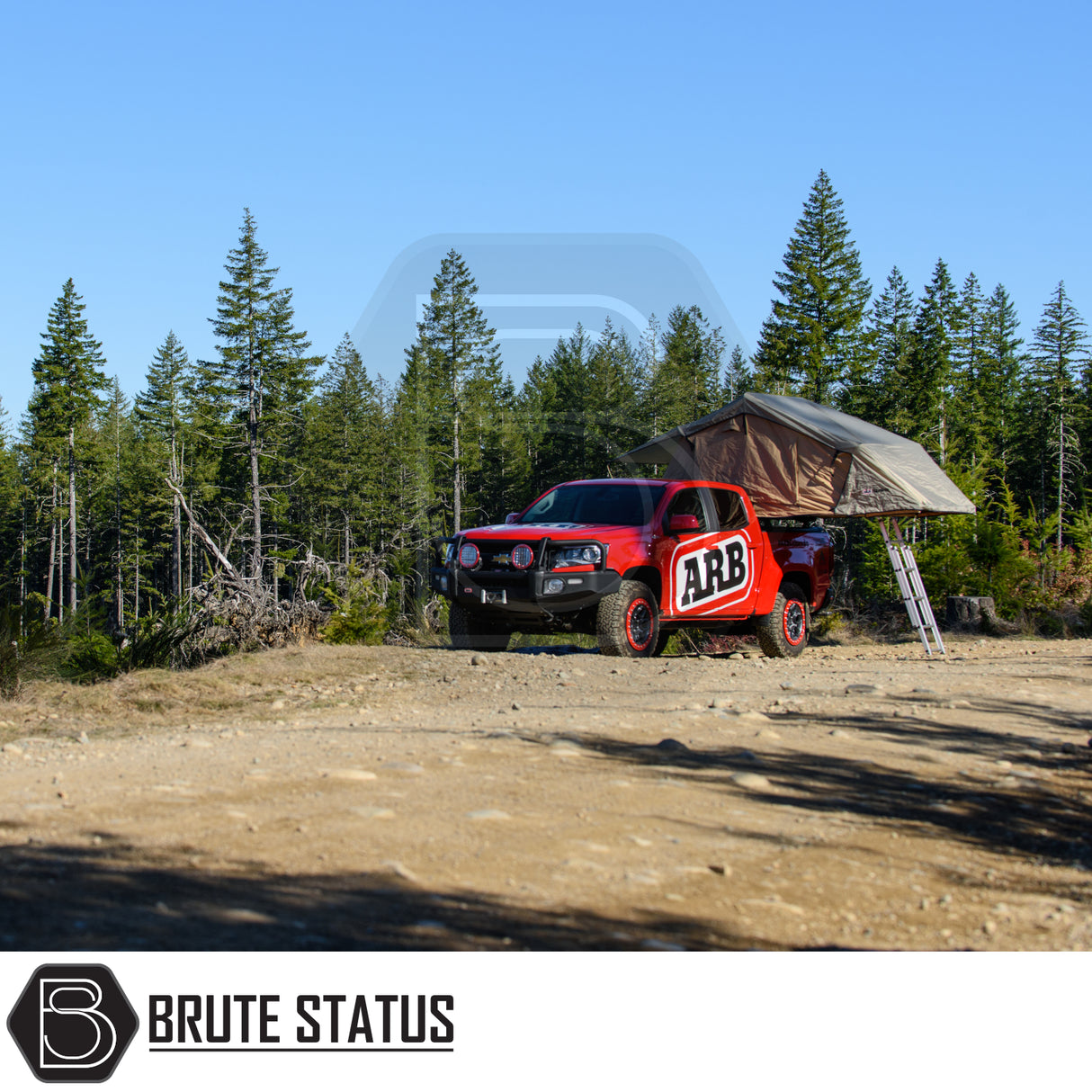 ARB Simpson III Rooftop Tent & Annex on a red pickup in a forest, showcasing off-road capability and convenient elevated camping for adventure enthusiasts.