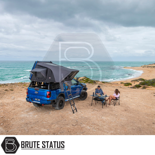 ARB Esperance 2.0 Rooftop Tent on blue Ford Ranger, setup on coastal bluff with campers enjoying the view.