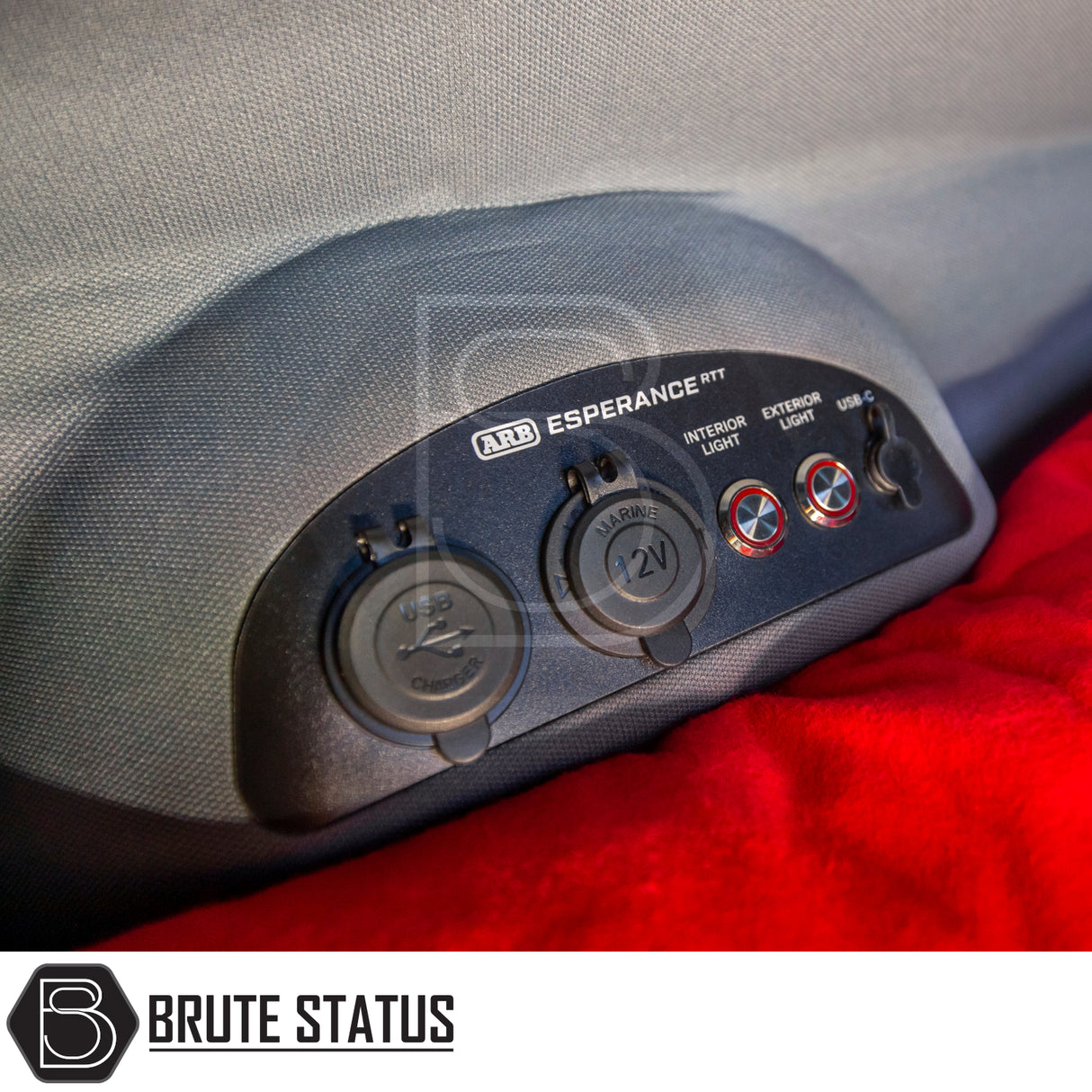 Close-up of ARB Esperance 2.0 Rooftop Tent's power panel featuring USB-A, 12V socket, interior/exterior light switches, and USB-C port, enhancing camping convenience.