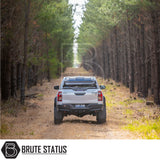 Toyota Hilux with ARB Esperance 2.0 Rooftop Tent on a dirt track; features streamlined hard shell and advanced camping enhancements.