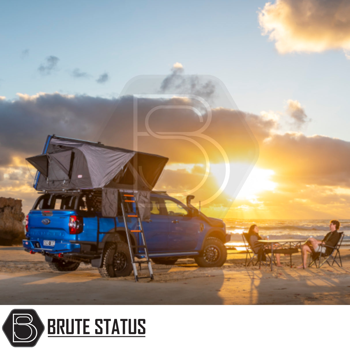 Rooftop tent ARB Esperance 2.0 on a blue pickup at sunset beach, showcasing overland camping lifestyle with Brute Status enhancements.