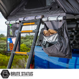 ARB Esperance 2.0 Rooftop Tent on blue pickup, featuring a telescoping ladder and organizer pouches with camp shoes and toiletries, highlighting overland-camping convenience.