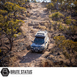 Expedition vehicle with ARB Altitude Rooftop Tent on rocky terrain, featuring automated setup, premium design, and off-road capabilities, showcased by Brute Status.