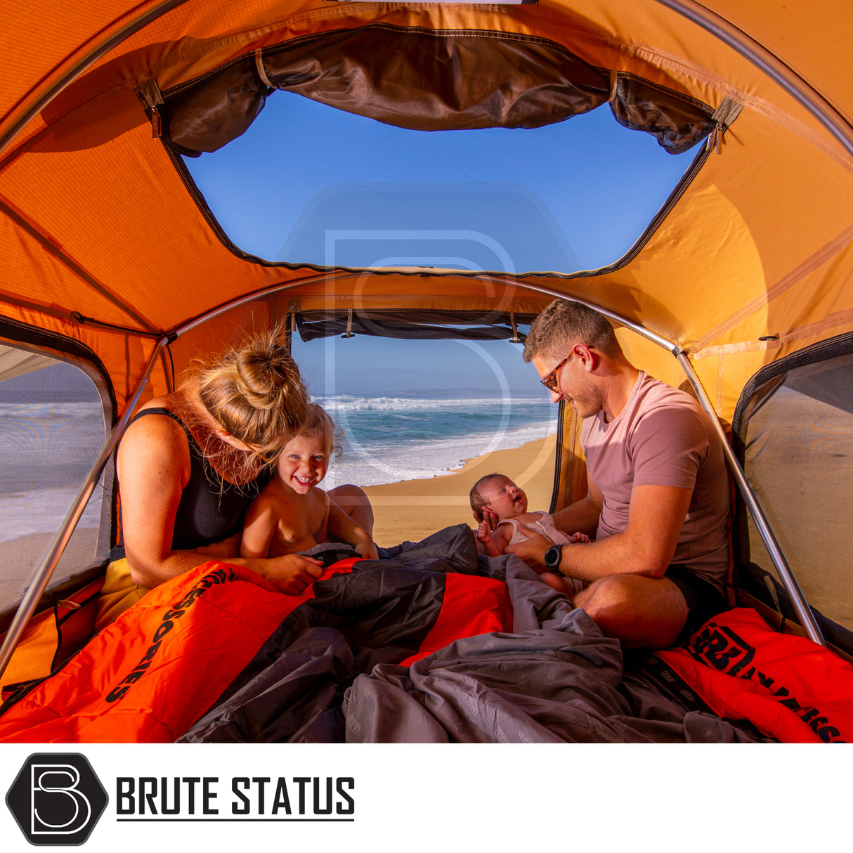 Family in orange camping tent on beach, showcasing ARB Flinders Rooftop Tent's spaciousness and comfort for two adults, highlighting camping convenience and beachside relaxation.