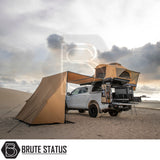 Off-road camping setup featuring an ARB Flinders Rooftop Tent on a pickup, showcasing its pop-up design, retractable ladder, and slide-out kitchen.
