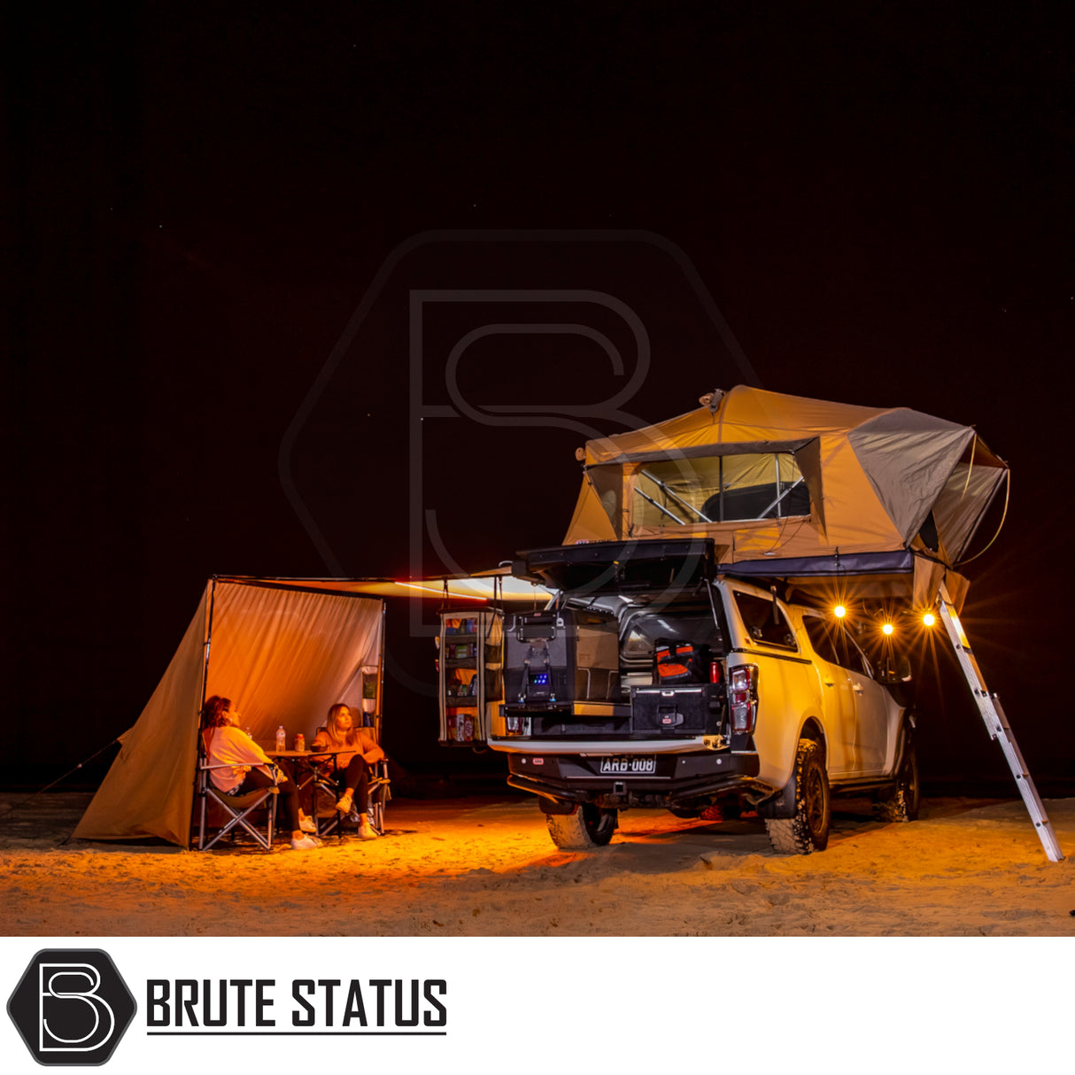Brute Status ARB Flinders Rooftop Tent on 4x4 ute, pop-up tent, camp kitchen, under awning with chairs, showcasing compact, durable camping setup for two.
