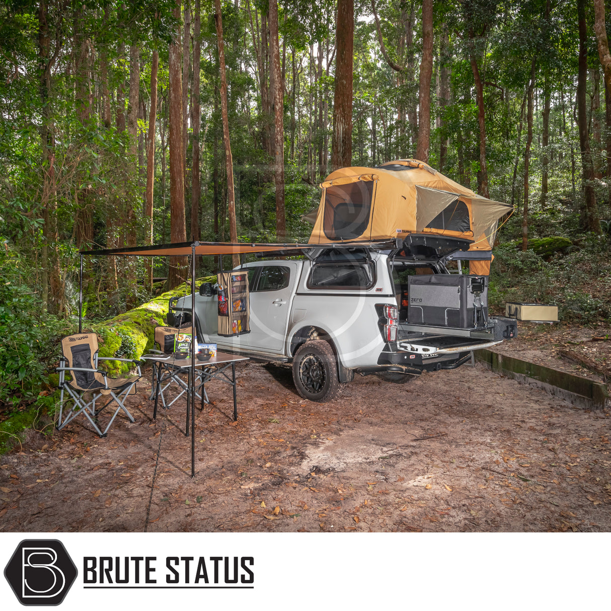 Off-road pickup with ARB Flinders Rooftop Tent, awning, and camping setup in forest clearing, showcasing a compact and comfortable overlanding solution.