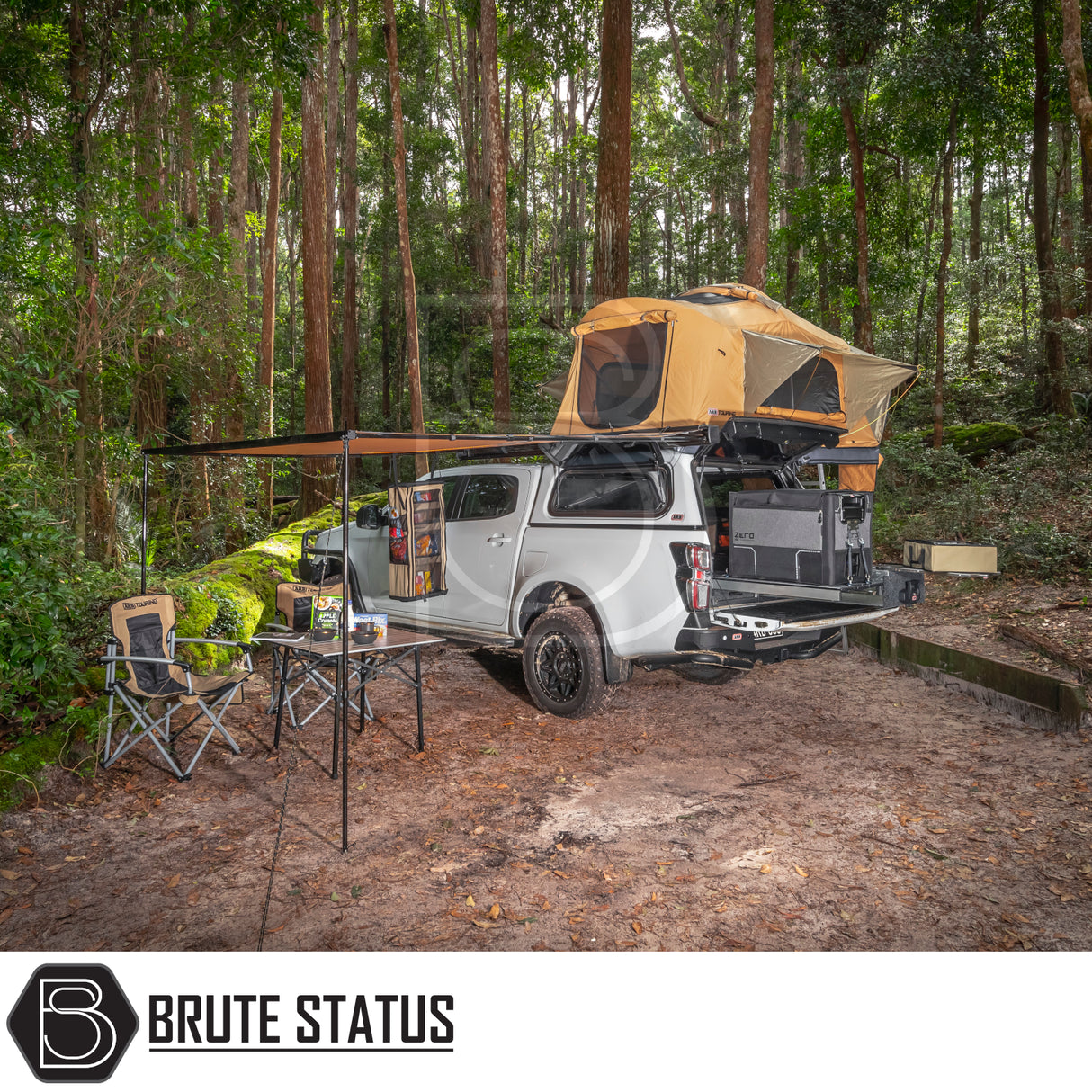 Overland camping setup featuring ARB Flinders Rooftop Tent on a white pickup truck with awning, camp chairs, and table, highlighting outdoor adventure and comfort.