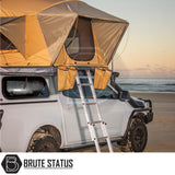 4x4 pickup with ARB Flinders Rooftop Tent on a beach at sunset, featuring a pop-up tan tent and ladder, ideal for adventurous truck enhancements.