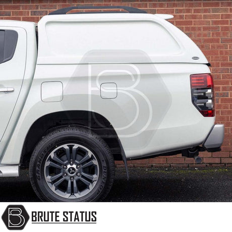 Fiat Fullback/Mitsubishi L200 Truckman L-Series Canopy: solid-sided, remote locking hardtop enhancing security and storage, seen fitted on a white pickup truck.