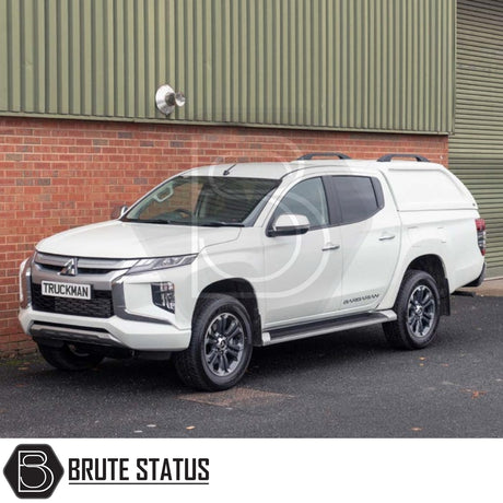 Mitsubishi L200 with Truckman L-Series Hardtop Canopy, featuring remote locking, parked in front of an industrial building. Tailored for enhanced security and storage.