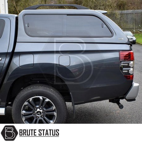 Rear view of a dark gray Mitsubishi L200 with Truckman GLS Hardtop Canopy featuring remote locking, tinted sliding windows, and tow hitch, ideal for enhanced storage and pet-friendly ventilation.
