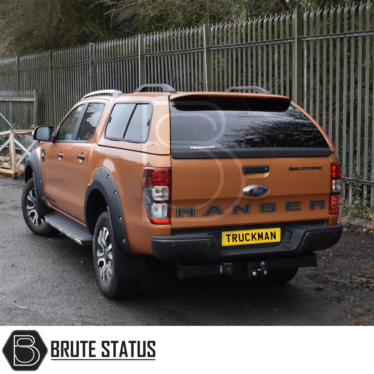 Orange Ford Ranger with Truckman GLS hardtop canopy, featuring remote locking, roof bars, and sliding windows for enhanced security and ventilation.
