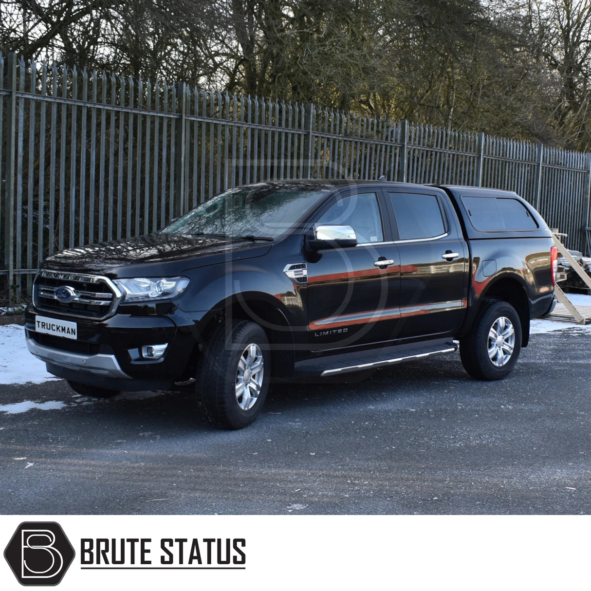 Black Ford Ranger with Truckman GLS Hardtop Canopy, featuring remote locking and roof bars, parked in front of a metal security fence, Brute Status logo visible.