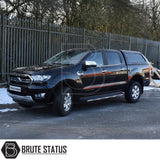 Black Ford Ranger with Truckman GLS Hardtop Canopy, featuring remote locking and roof bars, parked in front of a metal security fence, Brute Status logo visible.