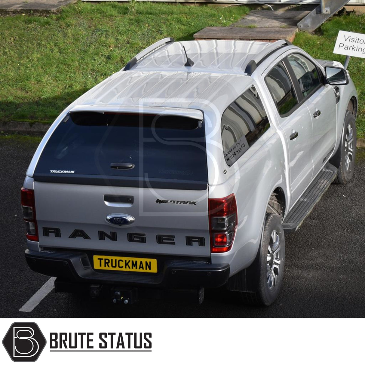 Silver Ford Ranger with Truckman Grand Hardtop Canopy, featuring tinted windows and remote locking, parked in a lot, showcasing aftermarket pickup truck enhancements.