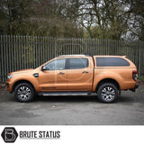 Metallic-orange Ford Ranger with Truckman Grand canopy, featuring remote locking and pop-out windows, parked in an outdoor setting.