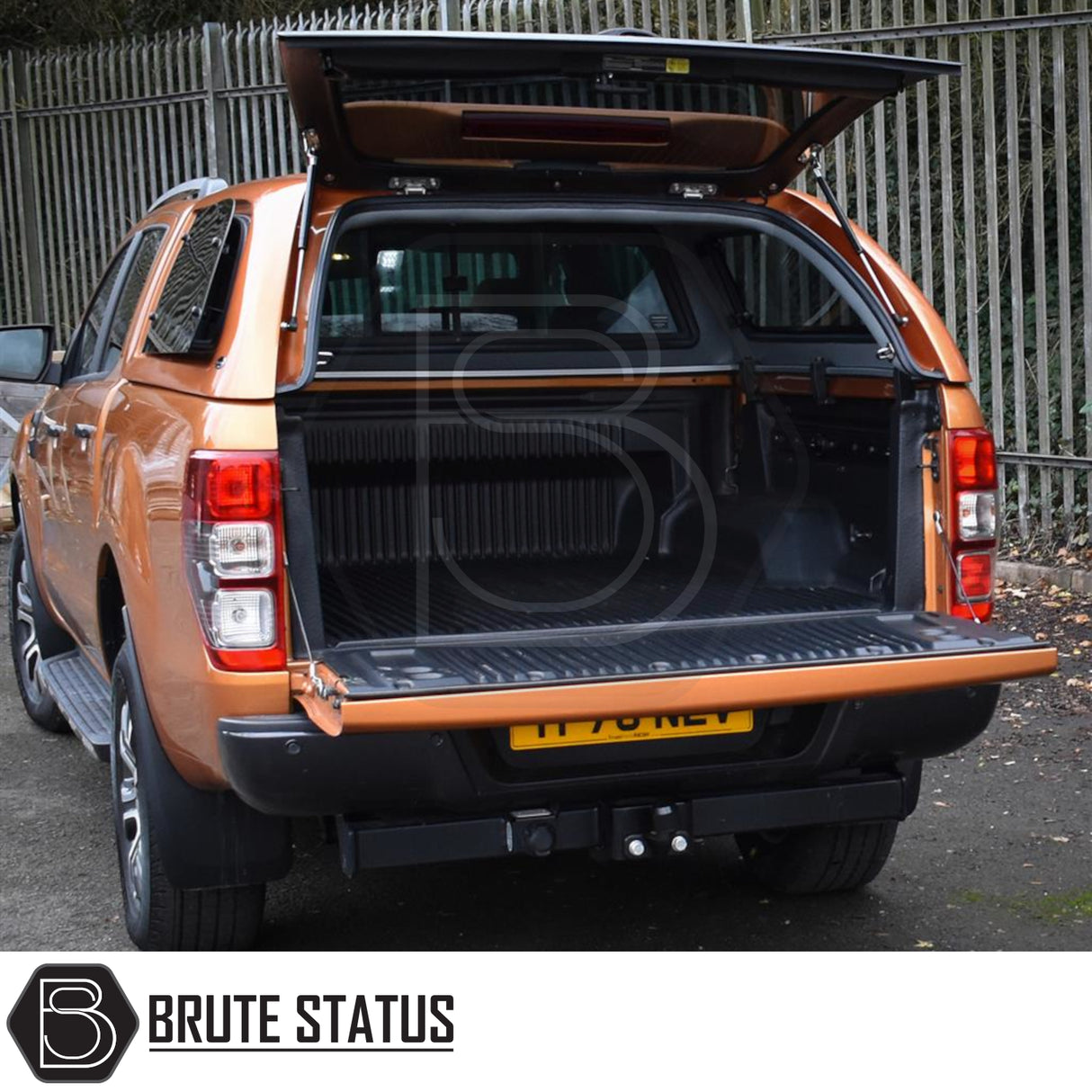 Orange crew-cab pickup with open Truckman Grand Hardtop Canopy for Ford Ranger 2012-2022, showcasing empty bed and Brute Status badge.