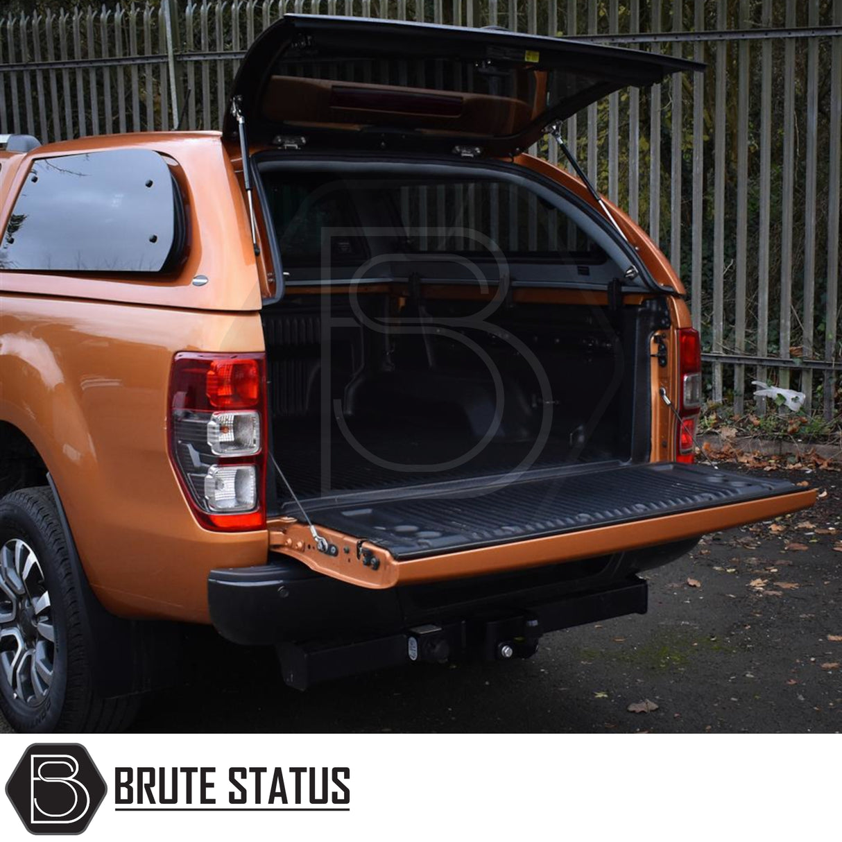 Ford Ranger Truckman Grand Hardtop Canopy with open hatch, revealing empty cargo bed. Brute Status branding visible, showcasing premium, secure pick-up truck accessory.