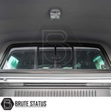 View from inside a Ford Ranger Truckman Grand Hardtop Canopy, showing ribbed bed liner, rear cab window, and overhead LED light.