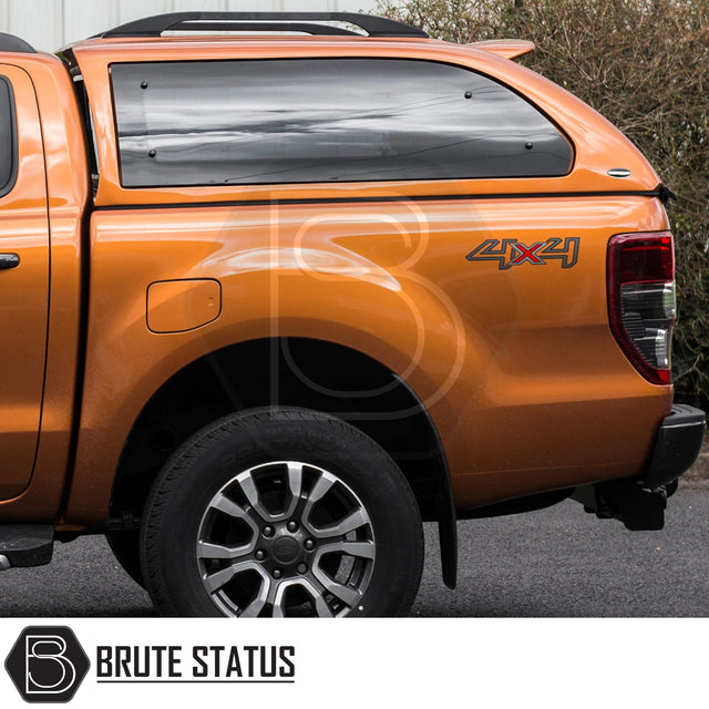 Ford Ranger 2012-2022 T6, T7, T8 Truckman Grand Hardtop Canopy with remote locking, roof bars, tinted windows, and aerodynamic design on an orange 4x4 pickup truck.