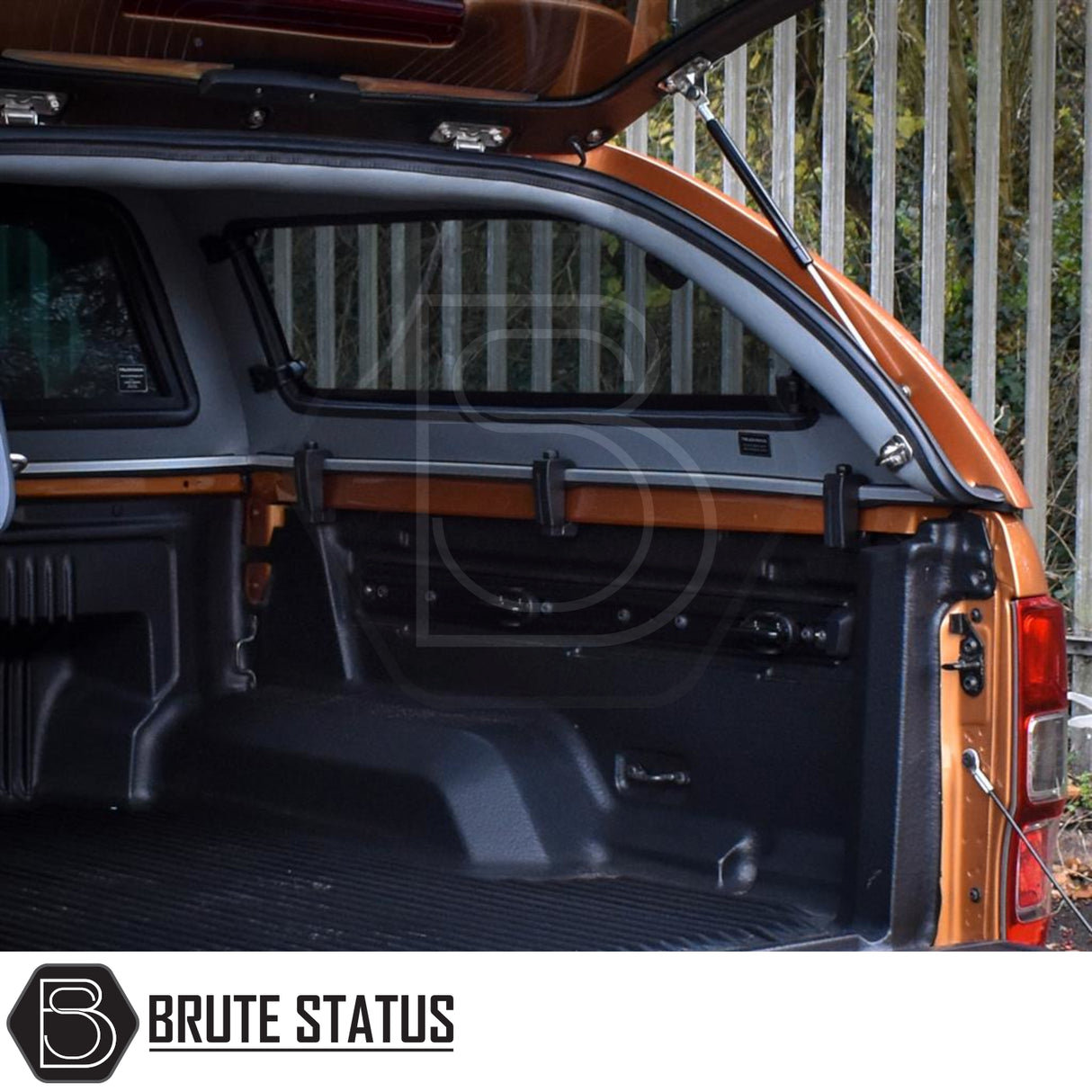 Ford Ranger Truckman Grand Hardtop Canopy features an open tailgate and canopy, showcasing the lined truck bed with tie-down points, highlighting enhanced storage and security.