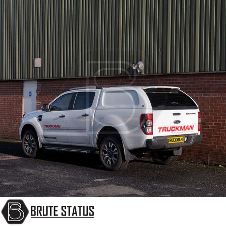 Ford Ranger 2012-2022 Truckman L-Series Hardtop Canopy with remote locking, enhancing storage and security, on a white double-cab pickup near an industrial building.