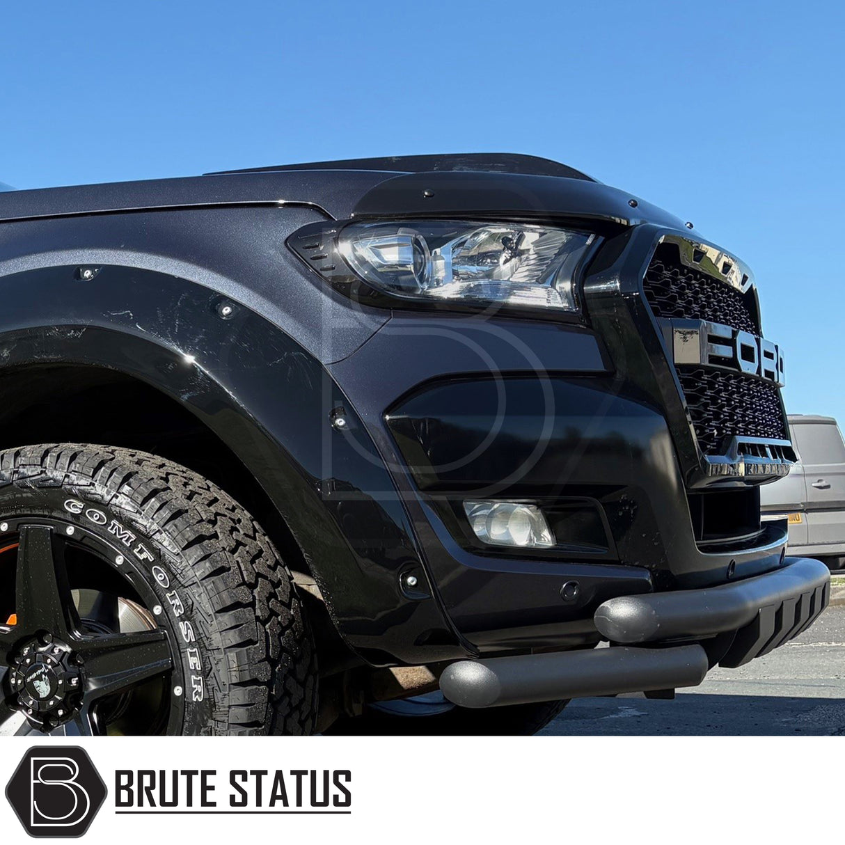 Front headlight covers in gloss black, pre-installed with strong 3M tape adhesive mounted onto front of Ford Ranger pick up truck offroad 4x4 vehicle. 