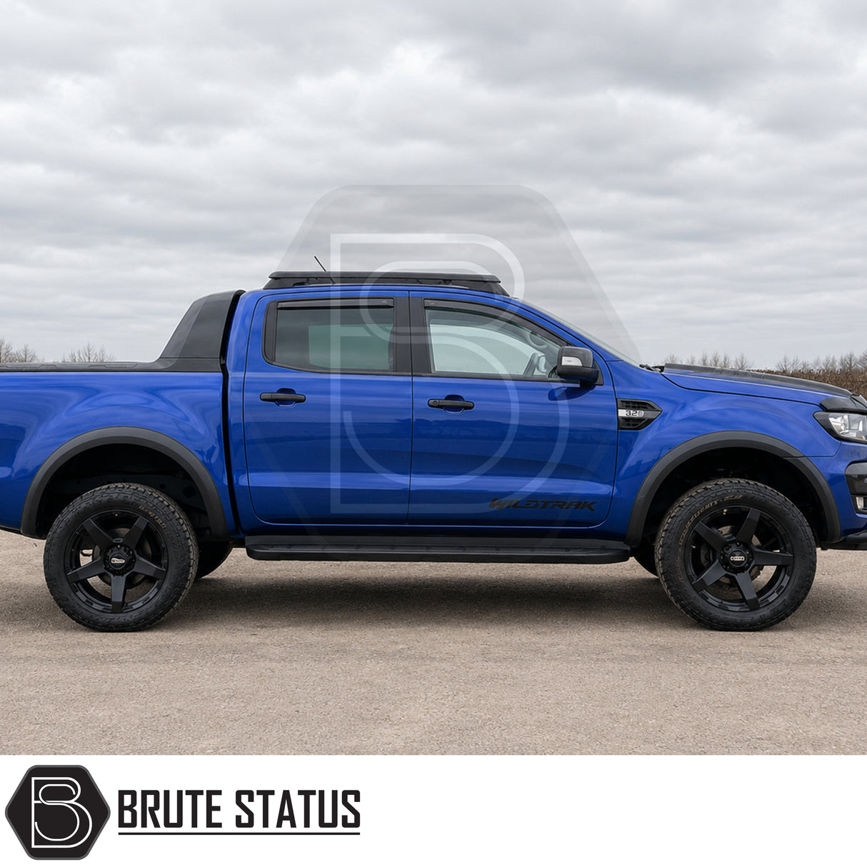 Smooth matte black ABS plastic wheel arch kit fitted onto blue Ford Ranger pickup truck offroad 4x4 vehicle. 