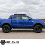 Smooth matte black ABS plastic wheel arch kit fitted onto blue Ford Ranger pickup truck offroad 4x4 vehicle. 