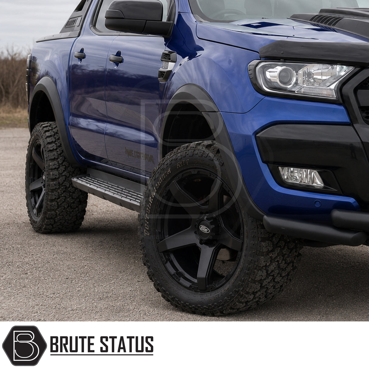 Front and rear smooth matte black wheel arch kit fitted to blue Ford Ranger pickup truck offroad 4x4 vehicle with upgraded alloys. 