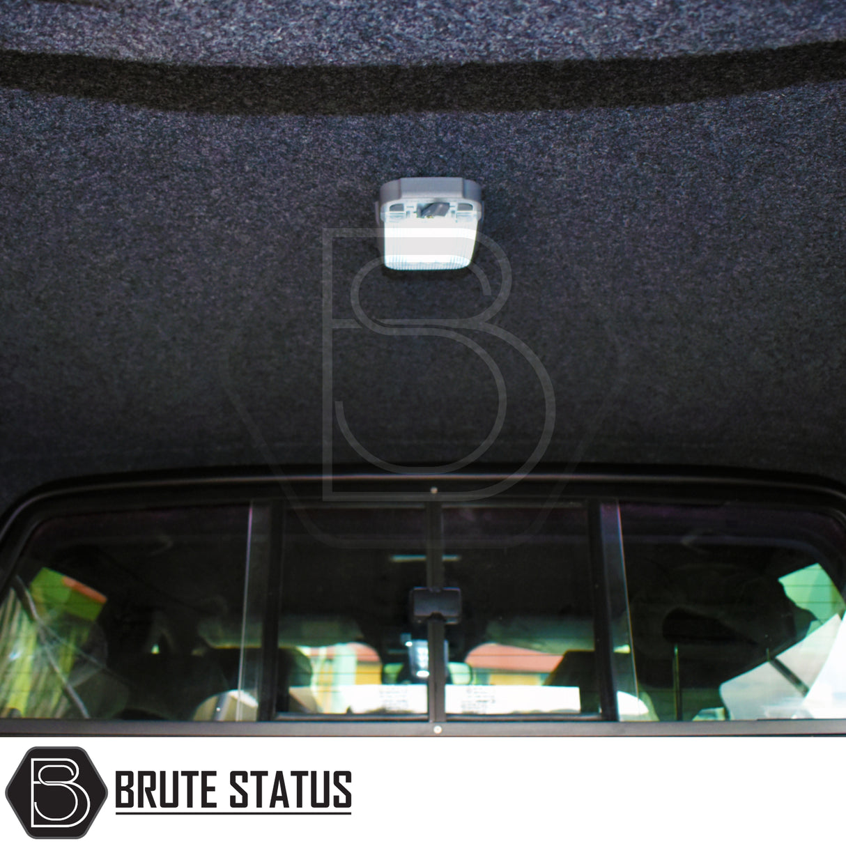 Interior view of Ford Ranger 2023+ T9 Truckman GLS Hardtop Canopy featuring a central LED dome light and Brute Status logo on carpeted ceiling.