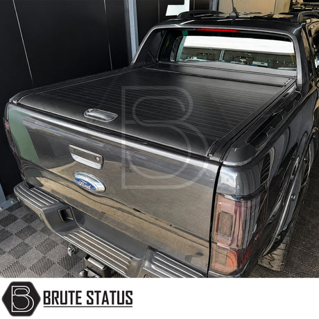 Rear smooth black finish roller shutter bed cover protector fitted to Ford Ranger Wildtrak with factory sports roll bar. Full mounting hardware included. 