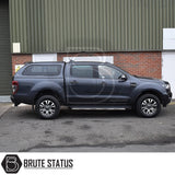 Ford Ranger pickup with Truckman GLS Hardtop Canopy featuring remote locking, tinted windows, and stylish design, parked near an industrial building.