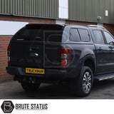 Ford Ranger with Truckman GLS hardtop canopy featuring remote locking and tinted windows, shown in a rear three-quarter view in front of a brick building.