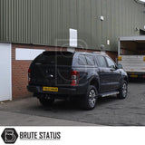 Ford Ranger 2012-2022 hardtop canopy with lockable, tinted sliding windows, parked by an industrial warehouse, showcasing Brute Status’s sporty, secure truck accessory.