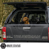 Isuzu D-Max 2012-2021 Truckman GLS Hardtop Canopy with remote locking, roof bars, and sliding windows, shown with two dogs in the truck bed.