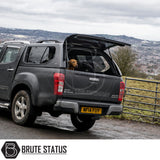 Isuzu D-Max 2012-2021 Truckman GLS Hardtop Canopy with remote locking and roof bars, featuring an open rear hatch with a dog inside.