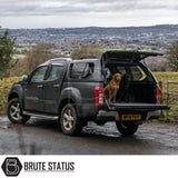 Isuzu D-Max 2012-2021 Truckman GLS Hardtop Canopy with remote locking and roof bars, shown on a parked pickup with two dogs in the bed.