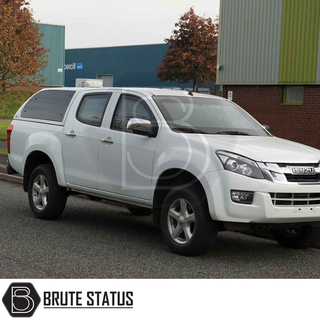 Isuzu D-Max 2012-2021 Truckman Grand Hardtop Canopy with remote locking, featuring cab-high design and tinted windows, on a white pickup truck in an industrial setting.