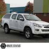 Isuzu D-Max 2012-2021 Truckman Grand Hardtop Canopy with remote locking, featuring cab-high design and tinted windows, on a white pickup truck in an industrial setting.