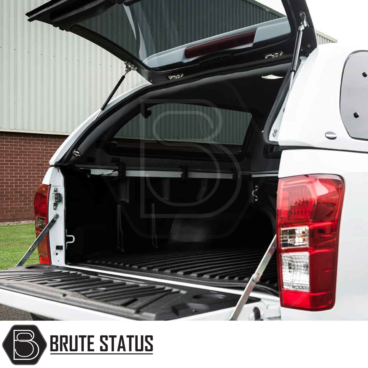 Rear view of an Isuzu D-Max 2012-2021 Truckman Grand Hardtop Canopy with remote locking, tailgate down, showcasing bed liner and canopy with Brute Status logo.