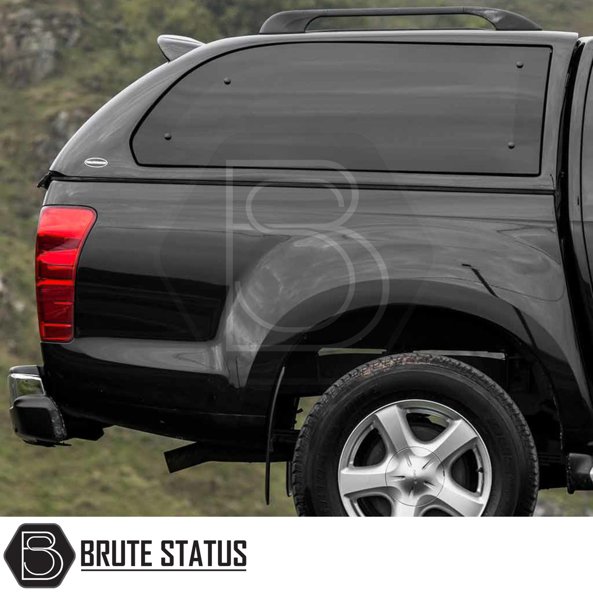 Isuzu D-Max 2012-2021 Truckman Grand Hardtop Canopy with remote locking, showcasing its sleek design and matching black fiberglass canopy on the rear-quarter of the pickup truck.
