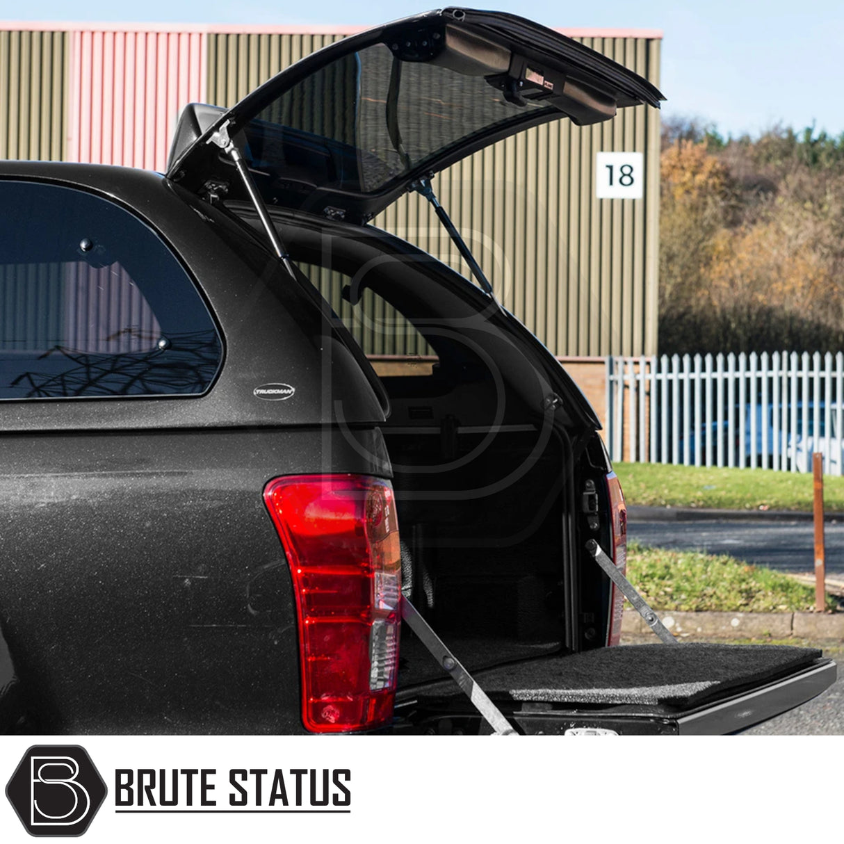 Isuzu D-Max 2012-2021 Truckman Grand Hardtop Canopy with open rear hatch and tailgate, showcasing carpeted load area and tinted windows for enhanced security and utility.