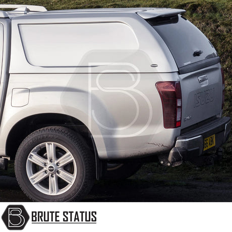 Silver Isuzu D-Max with Truckman L-Series Hardtop Canopy, showcasing rear view with tow hitch and alloy wheel; emphasizes security and storage enhancement.